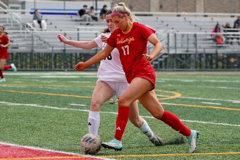 Batavia’s Natalie Warner (17) plays the ball against Oswego East's Keelan Quick during a soccer match at Batavia High School on Saturday, March 29, 2025.