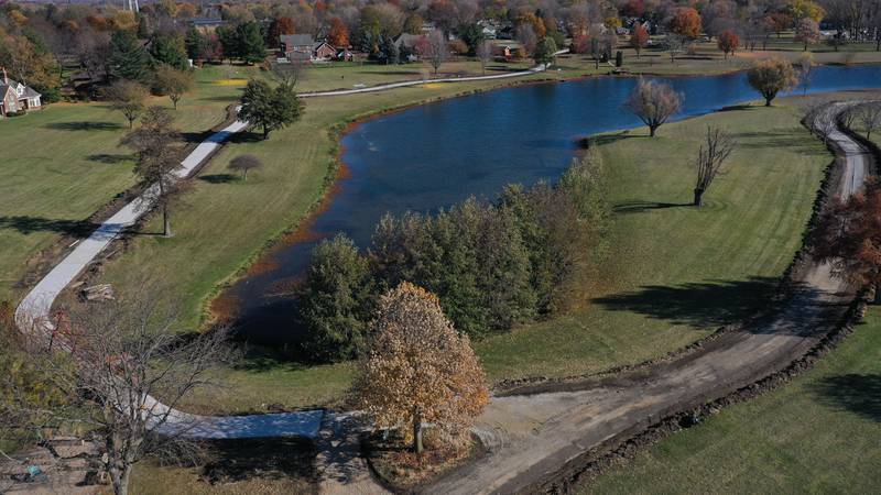 An aerial view of the construction around Baker Lake on Monday, Nov. 10, 2025 in Peru. The walking path is nearly half poured. It's been one-month since construction began. Work includes a 10-foot wide concrete path with secondary concrete paths also added, connecting with the new parking lot near Lighted Way and connecting with the parking lot, playground, and shelter on the west side of Baker Lake. The new path will be wider by 2 feet than the current one. The park remains closed to the public. The project will be completed in early December.