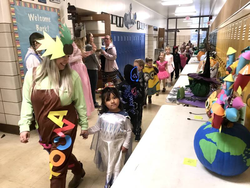 Mrs. Streicher leads her kindergarten class in the Halloween parade at Jefferson Elementary School in Ottawa on Monday, Oct. 31, 2022.