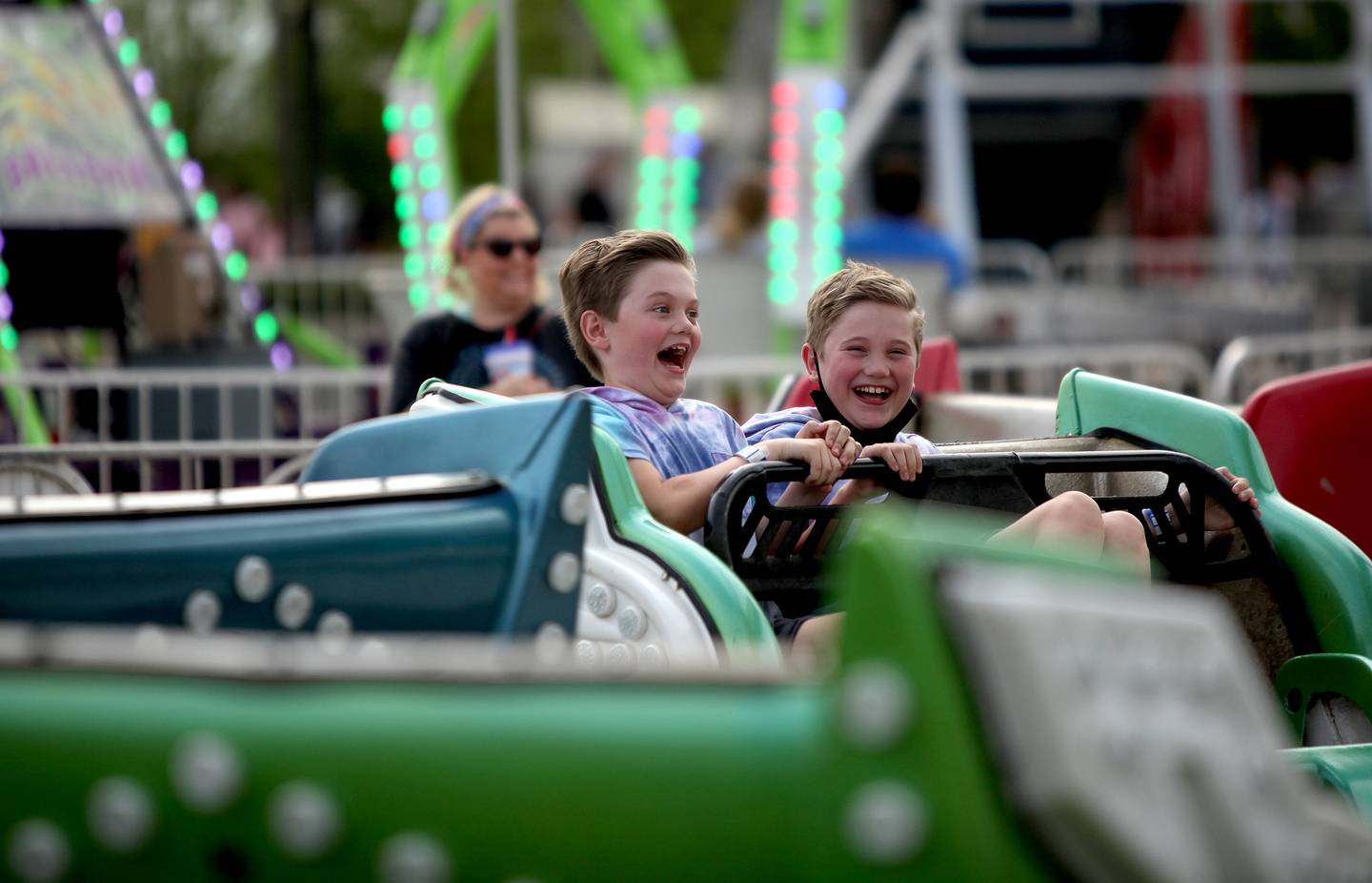 Twins Nick (left) and John Bronec, 10, ride the Sizzler during the 2021 Kane County Fair in St. Charles on Thursday, July 15, 2021.