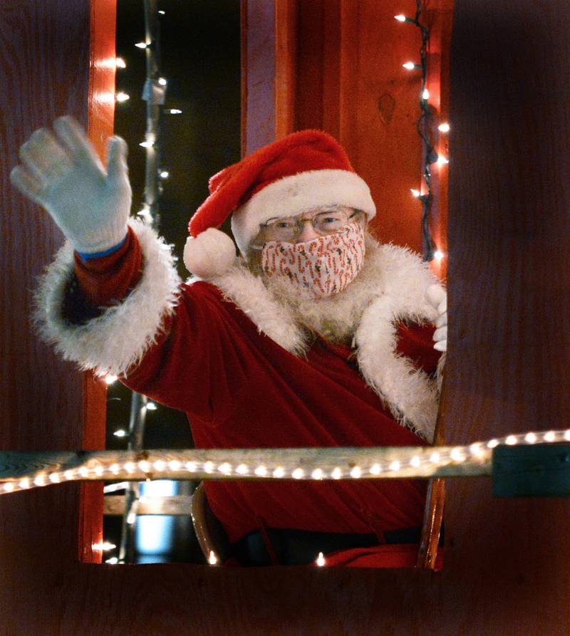 Santa Claus makes his way through the Marseilles parade earlier this month. Santa will be visiting girls and boys Thursday night.