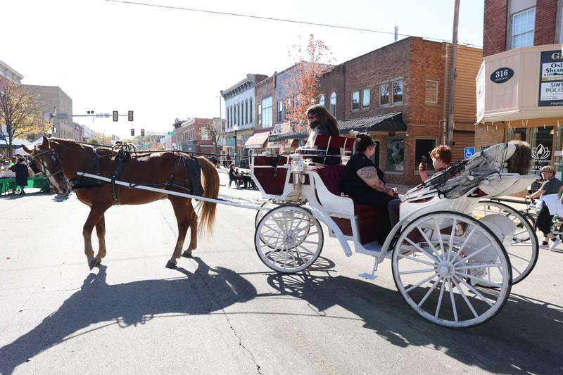 A family rides a horse carriage along Liberty Street at the Magic in Morris event on Saturday.