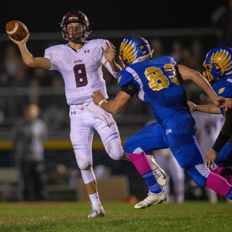 Marengo Quarterback Travis Knaak throws on the run Friday against Johnsburg. Marengo won, 16-14, to take sole possession of first place in the Kishwaukee River Conference.