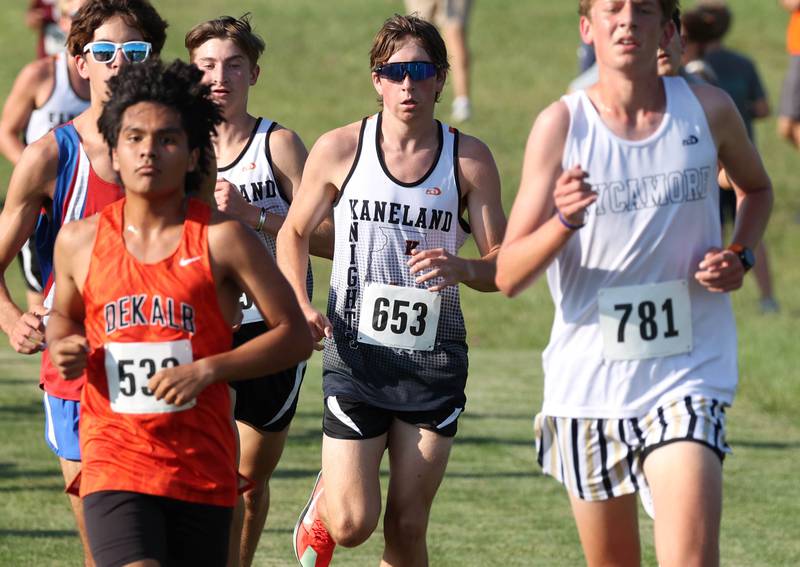 Dekalb’s Andy Duran, (left) Kaneland’s Gavin Schnurstein and Sycamore’s Liam Berry (right) run together in a pack Tuesday, Sept. 2, 2025, during the Sycamore Cross Country Invitational at Northern Illinois University in DeKalb.
