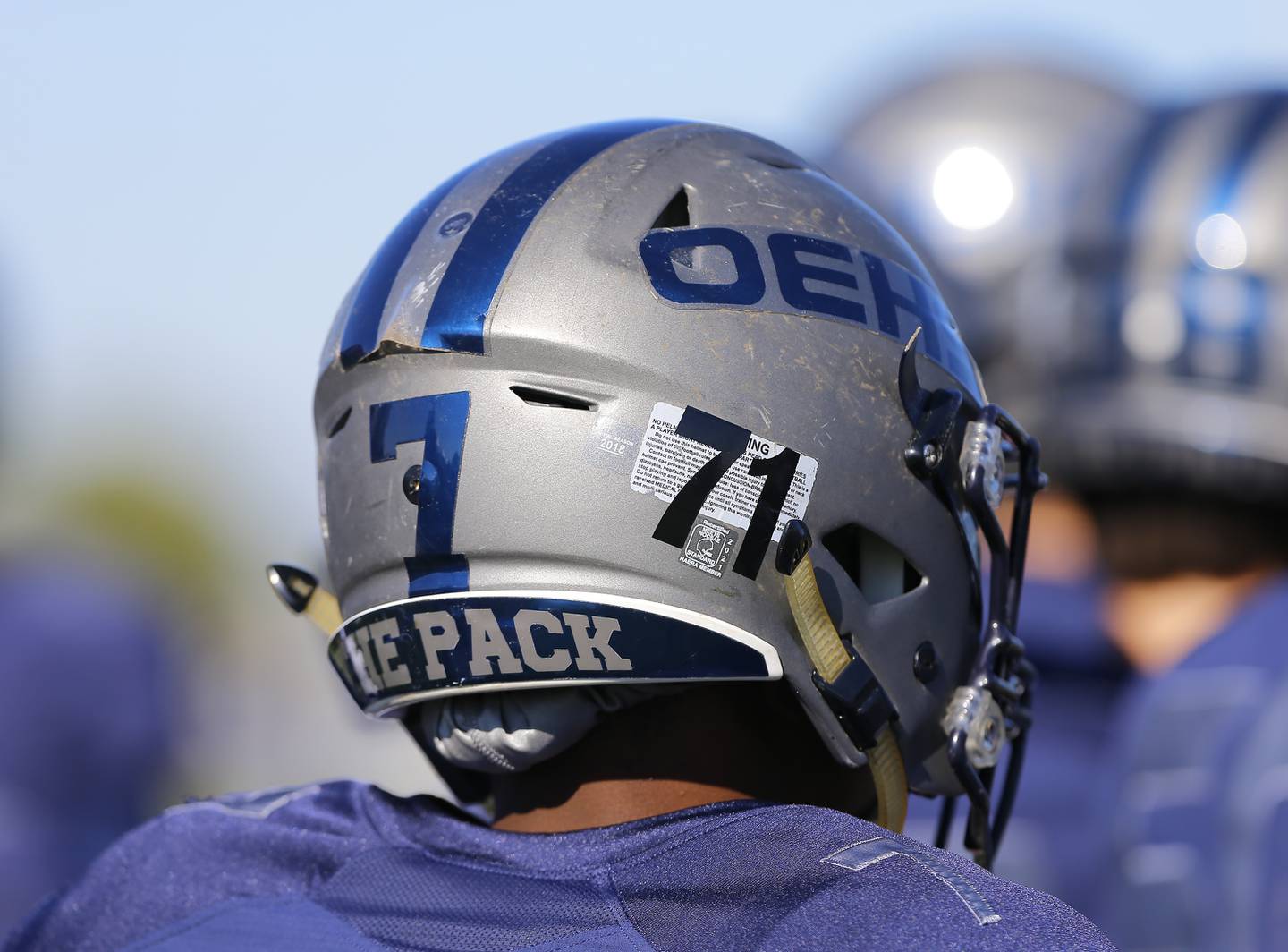 Oswego East's team helmets display Mark Chapas' number 71 during the varsity football game between Plainfield North and Oswego East on Saturday, October 23, 2021 at Oswego East high school in Oswego, IL.