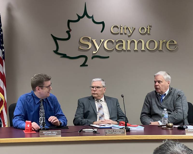 Sycamore City Manager, left; City Attorney Kieth Foster, middle; and Sycamore Mayor Steve Braser, right, talk during the Dec. 18, 2023, Sycamore City Council meeting. During that meeting, Hall announced Sycamore taxpayers will receive a rebate check because the city overtaxed property owners by nearly $120,000 in 2023.