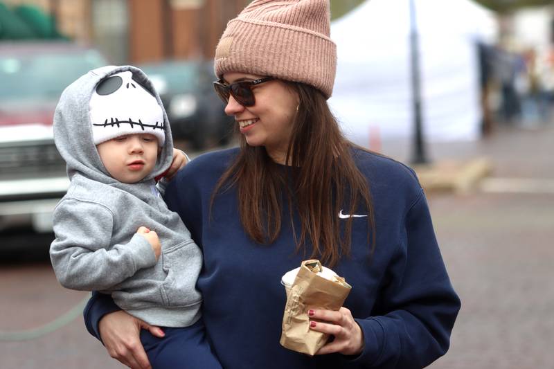 Madison Wekony of Woodstock strolls with her son Deklan, 1, during the farmers market Saturday, April 29, 2023, on the historic Woodstock Square.