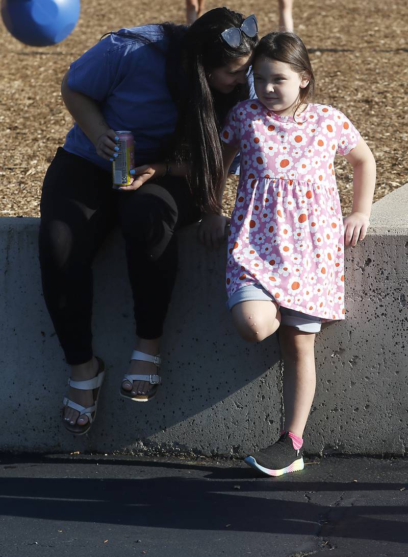 Kristin Pratt talks to her daughter, Crystal Quezada, 6, as the wait for school to start on the first day of school at West Elementary School in Crystal Lake on Wednesday, Aug. 16, 2023.