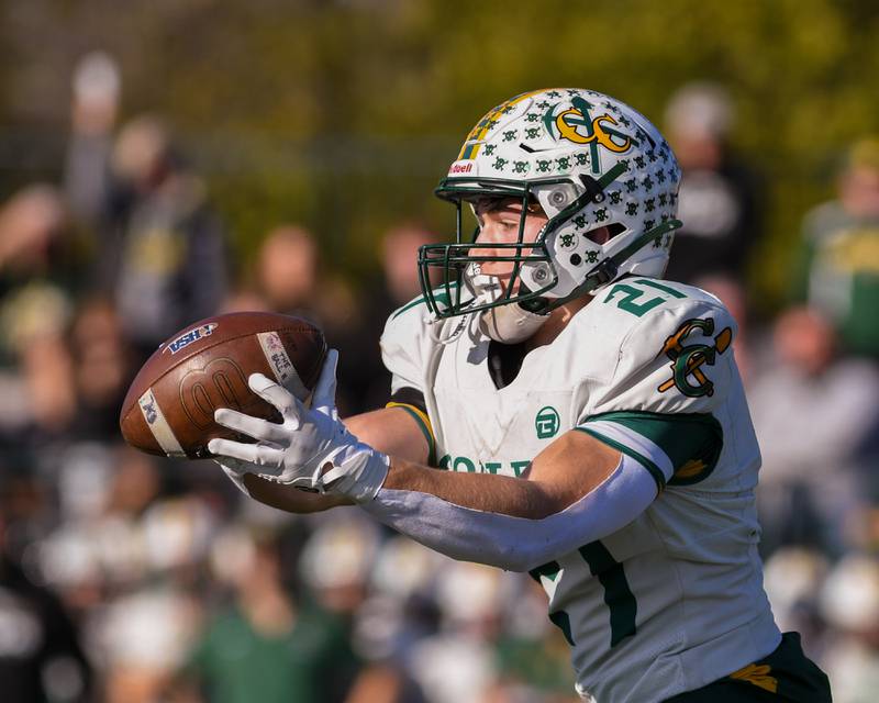 Coal City's Logan Natyshok (21) catches a pass and gains some yards while taking on Montini Catholic during the 4A quarterfinals game on Saturday Nov. 15, 2025, held at Montini Catholic High School.