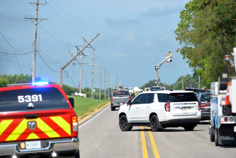 A ComEd worker assesses damage to power lines along Illinois Route 64 following a single plane accident near the Ogle County Airport between Oregon and Mt. Morris on Tuesday, July 22, 2025. The pilot of a crop dusting plane was killed after hitting power lines near the airport. A section of Illinois Route 64 was closed for ComEd crews to repair the damage.