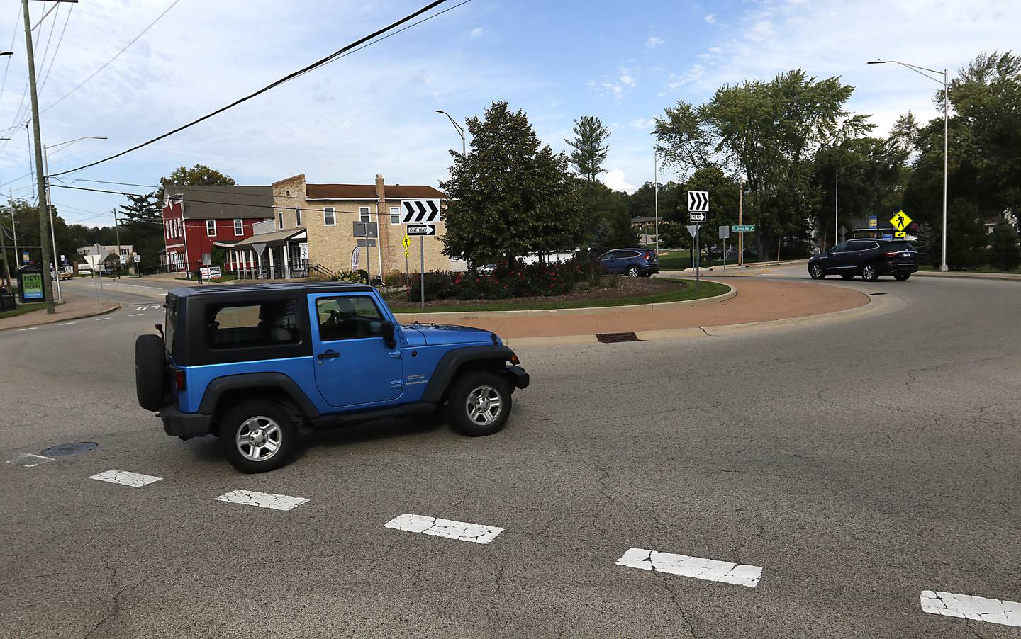 Traffic navigates the roundabout at the intersection of Johnsburg and North Chapel Hill roads on Tuesday, Sept. 20, 2022.  Roundabouts are a big part of planning and proposed solutions for traffic issues within McHenry County. There are half a dozen intersections where roundabouts are either planned or under construction and there are more sites that have been identified within McHenry County as being potentially suitable for roundabouts in the future. Data from Illinois Department of Transportation shows that roundabouts can significantly improve traffic and decrease both the number of crashes as well as the number of injuries and hospitalizations that occur when crashes do happen.