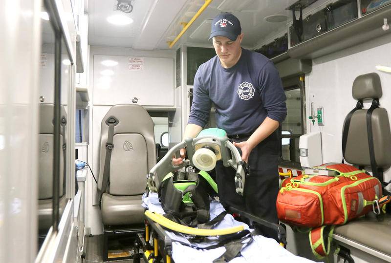 Joe Long, DeKalb Fire Department paramedic, demonstrates the use of a Lucas device in the back of an ambulance Wednesday at station 1. The machine, which performs CPR on a patient, frees up paramedics to perform other tasks to help revive an individual. The Lucas is just one of several tools and medications the ambulance carries on every call.