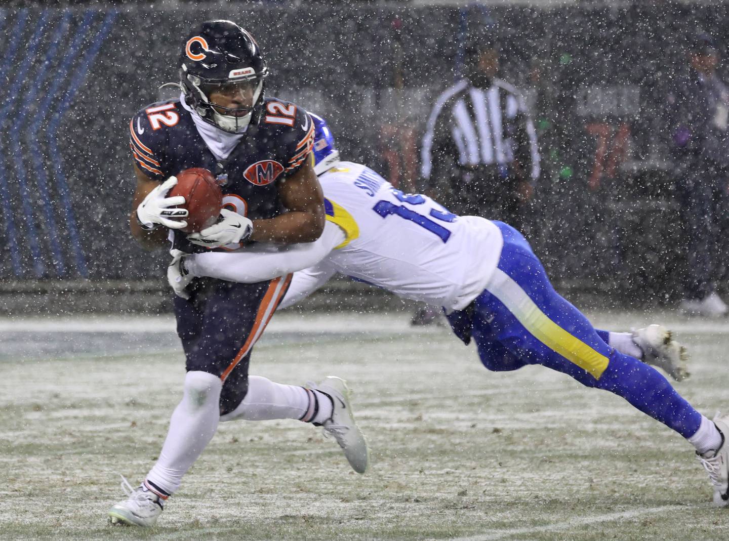 Chicago Bears returner Devin Duvernay tries to break away from Los Angeles Rams’ Xavier Smith on a punt return Sunday, Jan. 18, 2026, during their NFC divisional playoff matchup at Soldier Field in Chicago.