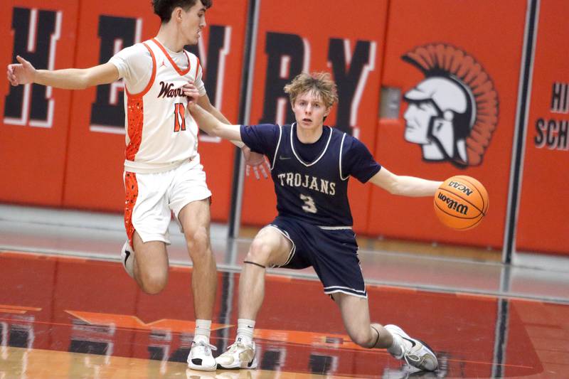 McHenry’s Haydn Schmidt, left, keeps pace with Cary-Grove’s Connor Strike in varsity boys basketball on Tuesday, Feb. 17, 2026, at McHenry High School in McHenry.