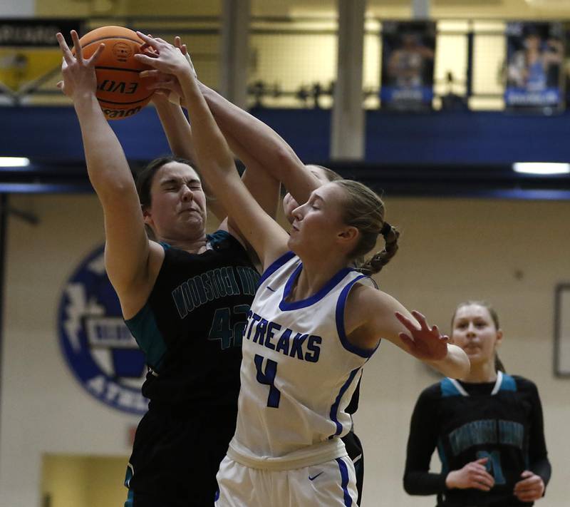 Woodstock North's Brenna McConnell grabs a reborn over Woodstock's Lily Novelle during a Kishwaukee River Conference basketball game on Friday, Jan. 10, 2025, at Woodstock High School.