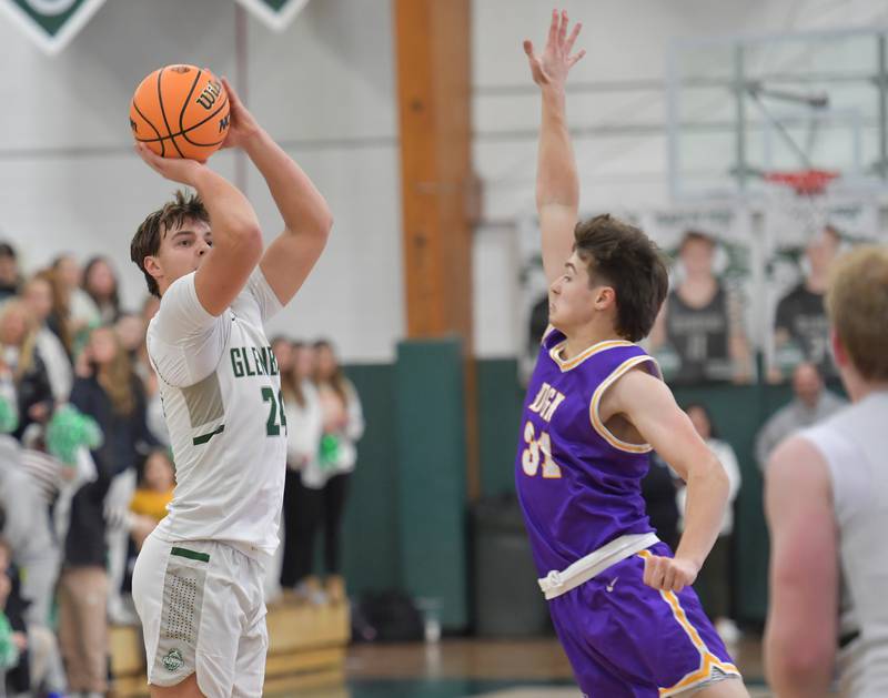 Glenbard West’s Brady Johnson (left) shoots a three pointer as Downers Grove North’s Robert Steffes defends during a game on January 23, 2026 at Glenbard West High School in Glen Ellyn.
