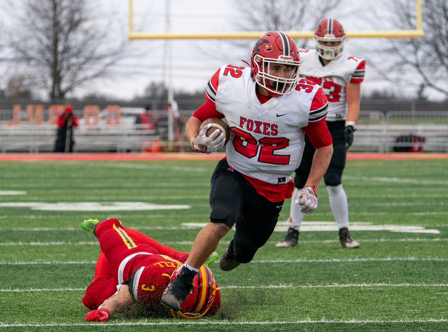 Yorkville's Gio Zeman (32) carries the ball against Batavia's Ryan Whitwell (3) for a touchdown during a 7A quarterfinal playoff football game at Batavia High School on Saturday, Nov 12, 2022.