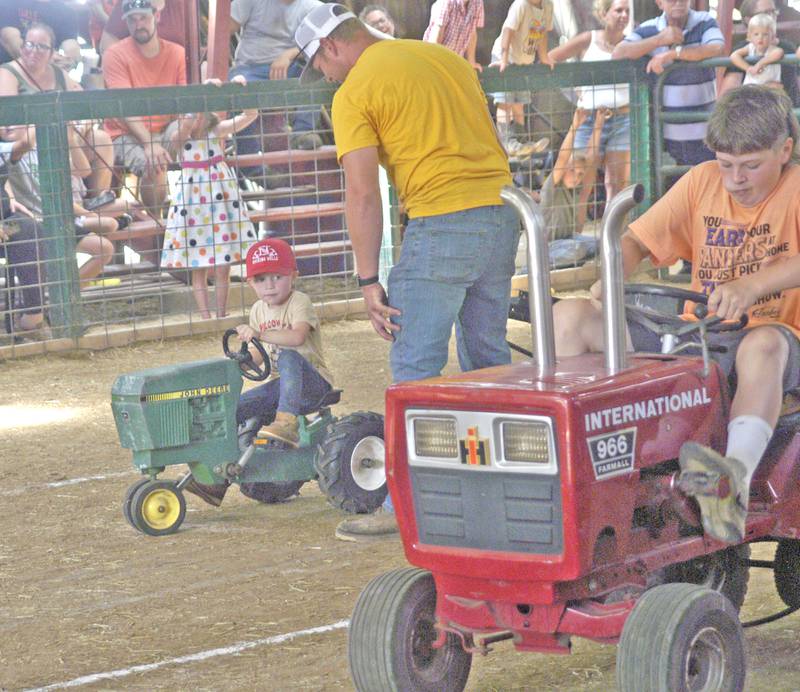 Two contestants in the pedal pull go at it Sunday. July 27, 2025, at the Lee County Fair near Amboy.
