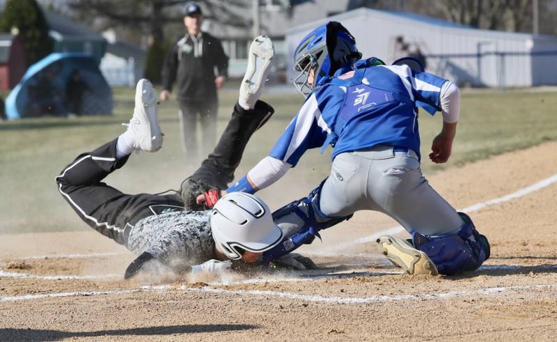 Rock Falls' Owen Mandrell slides in under the tag of Princeton catcher Ace Christiansen to score a first-inning run Thursday at Prather Field. The host Tigers won 5-4.