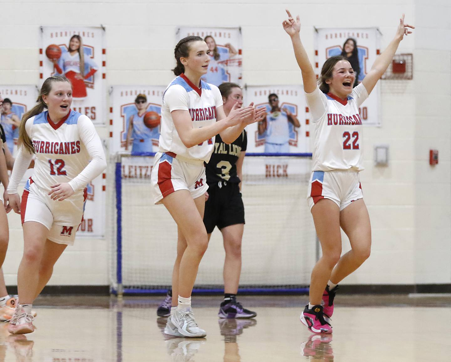 Marian Central's Jenna Remke, (right) Juliette Huff, (center) and Abbey Miner (left) celebrate their come from behind win over Rockford Christian in a nononference basketball game on Monday, Feb. 10, 2025, at Marian Central High School  in Woodstock.
