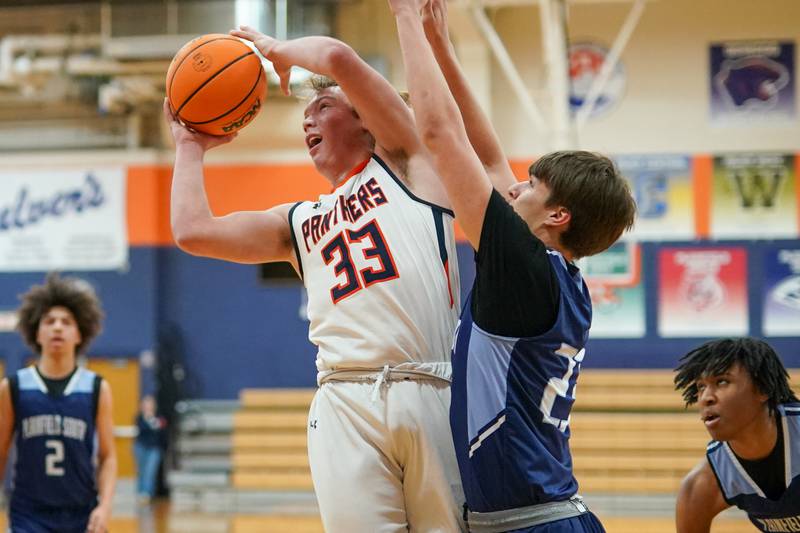 Oswego’s Graham Schwab (33) shoots the ball in the paint against Plainfield South's Brayden Ablin (22) during a basketball game at Oswego High School on Friday, January 17, 2025.