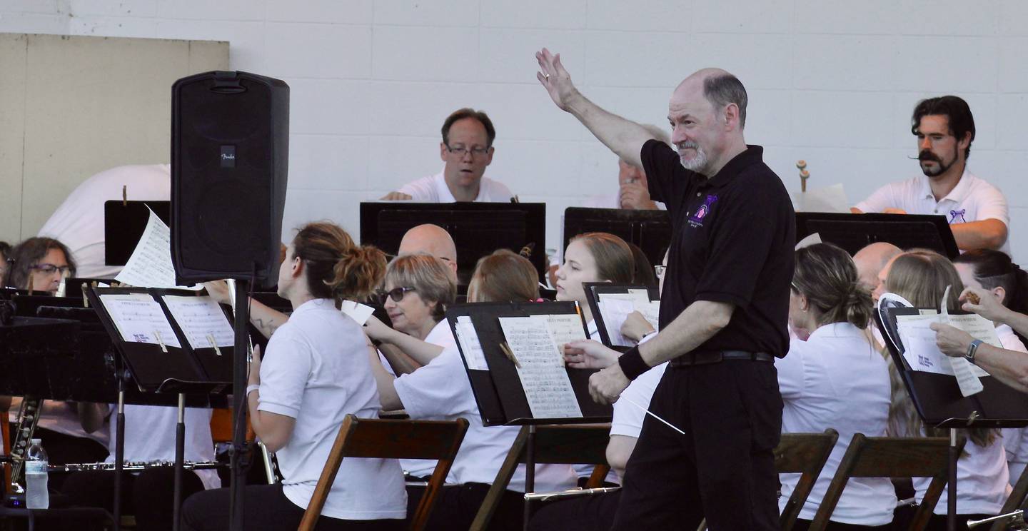 Conductor Jon James acknowledges the Dixon Municipal Band after its opening march for a Summer Series concert performance on Thursday at Page Park in Dixon.