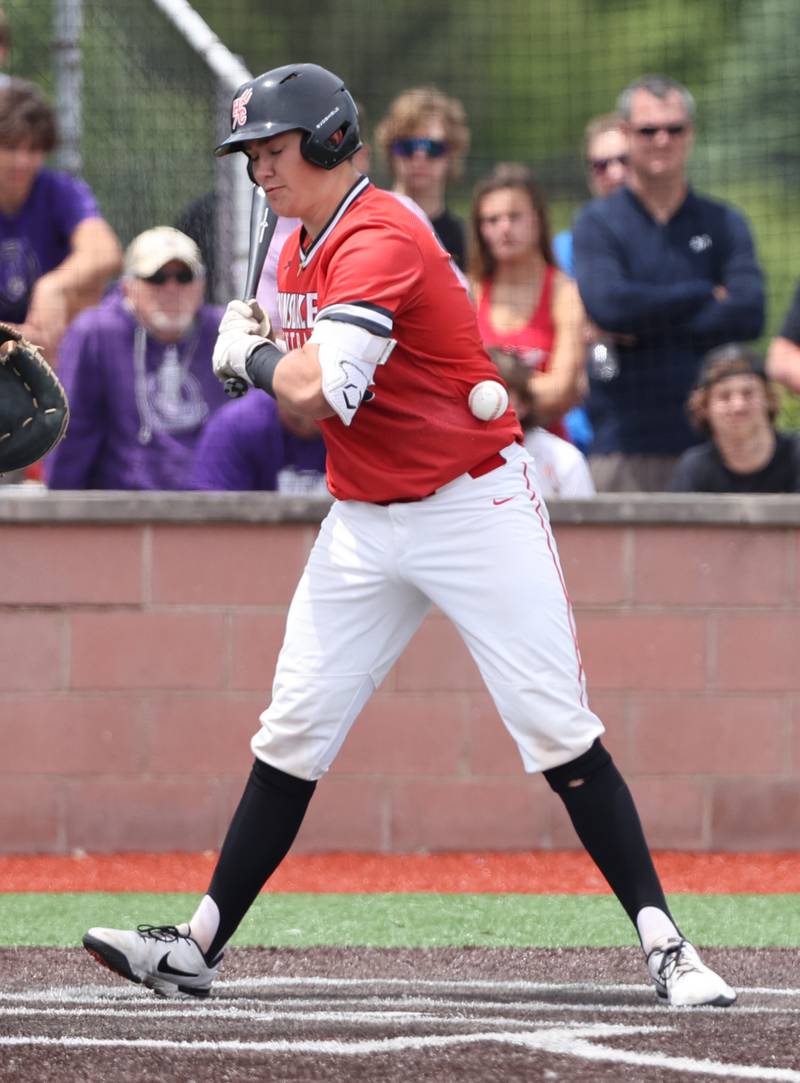 Hinsdale Central's Charles Bergin (18) is hit by a pitch during the IHSA Class 4A baseball regional final between Downers Grove North and Hinsdale Central at Bolingbrook High School on Saturday, May 27, 2023.