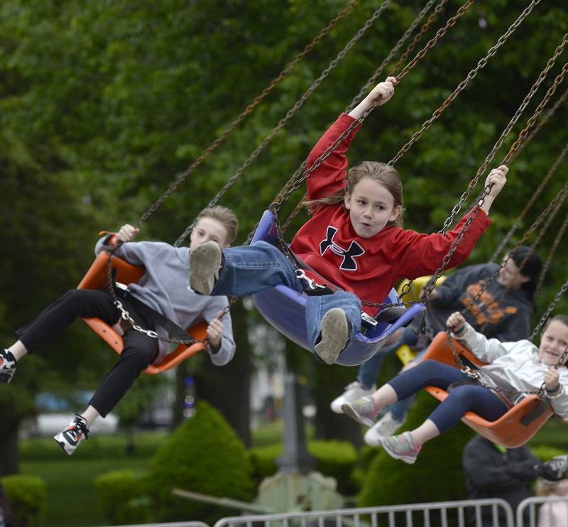 Conrad Shelton leads the way going through the air Friday, May 27, 2022, while riding the Flying Swing during Park Fest in Streator.