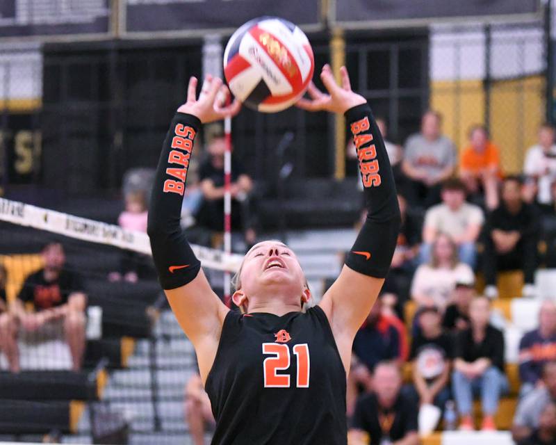 DeKalb's Maddi Hollar (21) sets the ball during the game while taking on Sycamore on Wednesday Aug. 27, 2025, held at Sycamore High School.