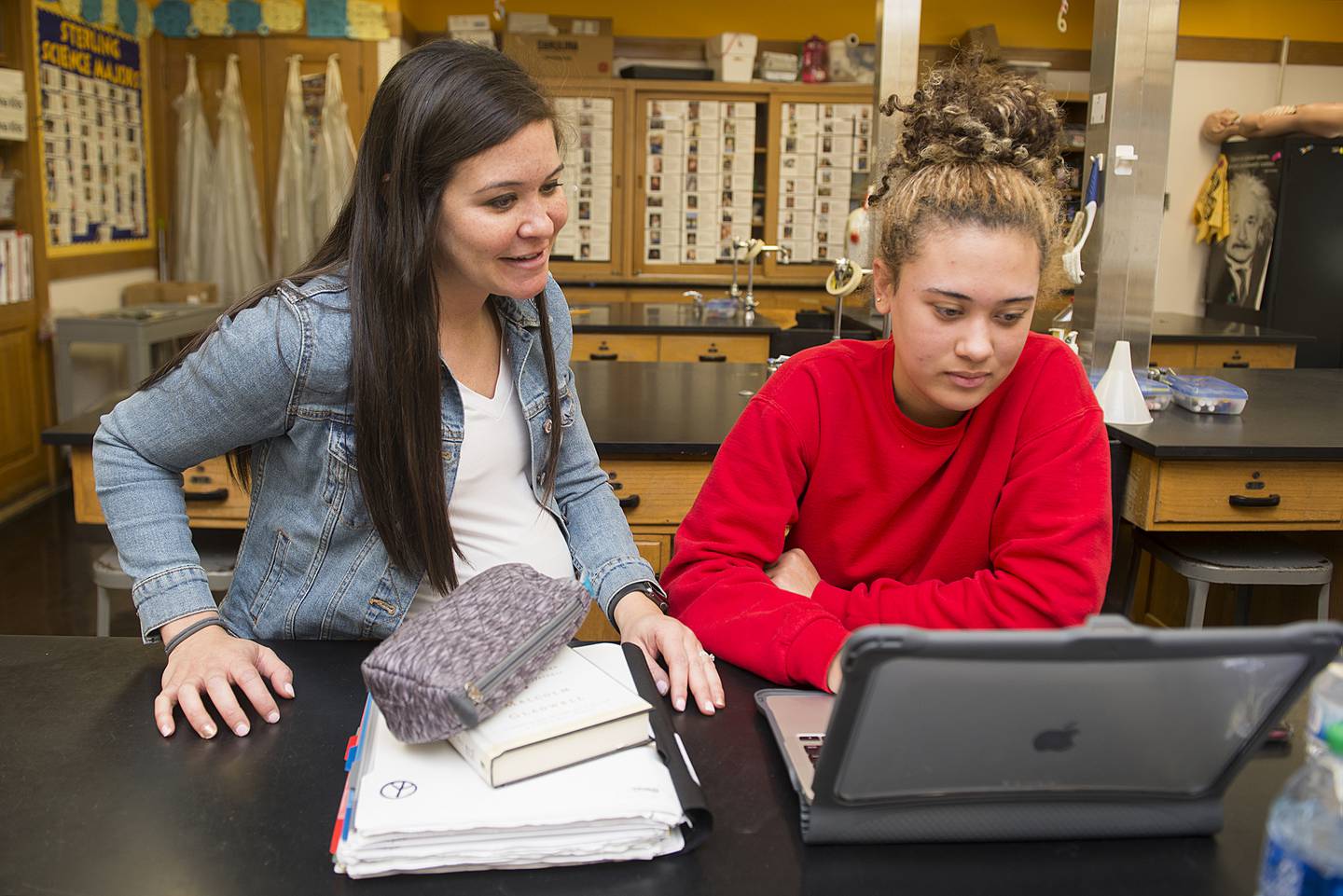 Sterling High School science teacher Nicole Schlemmer (left), works with junior student Ashyia Love Tuesday, April 19, 2022. Through the Young Doctors League, Schlemmer is helping to prepare the next generation of medical professionals before they get to college.