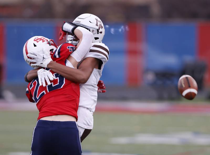 St. Rita's Andrew Elwood (23) gets in the face of Mt. Carmel's Marshawn Throton (80) resulting in a pass interference penalty during the class 7A semi-final playoff game between Mt. Carmel and St. Rita high schools on Saturday, Nov. 23, 2024 in Chicago.