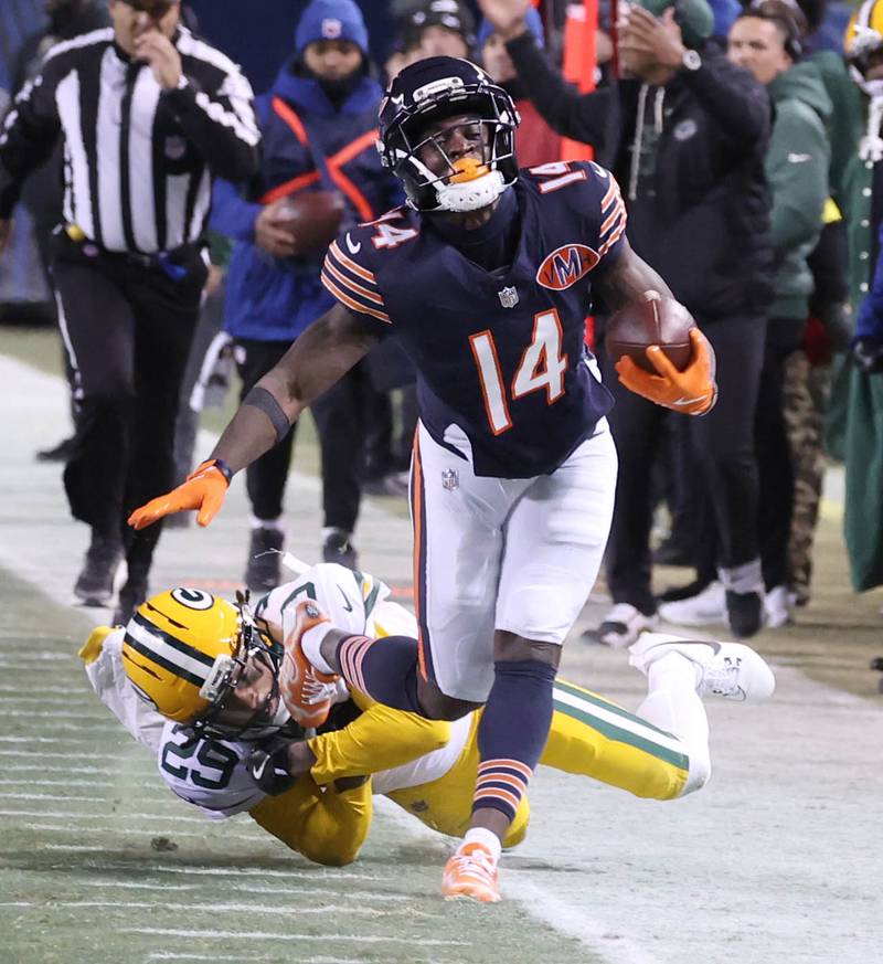 Chicago Bears wide receiver Olamide Zaccheaus tries to pull away from Green Bay Packers safety Xavier McKinney after a reception Saturday, December 20, 2025, during their game at Soldier Field in Chicago.