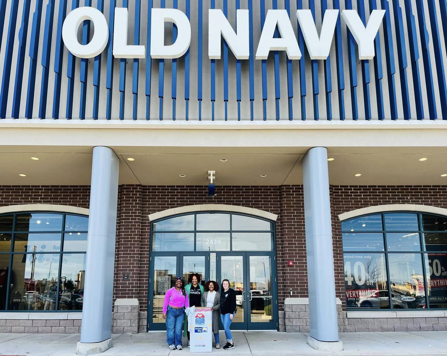 Old Navy staff, Stacie Miller of Kishwaukee United Way and United Way executive director Michele Vaughn pose for a photo outside the Old Navy outlet in DeKalb.