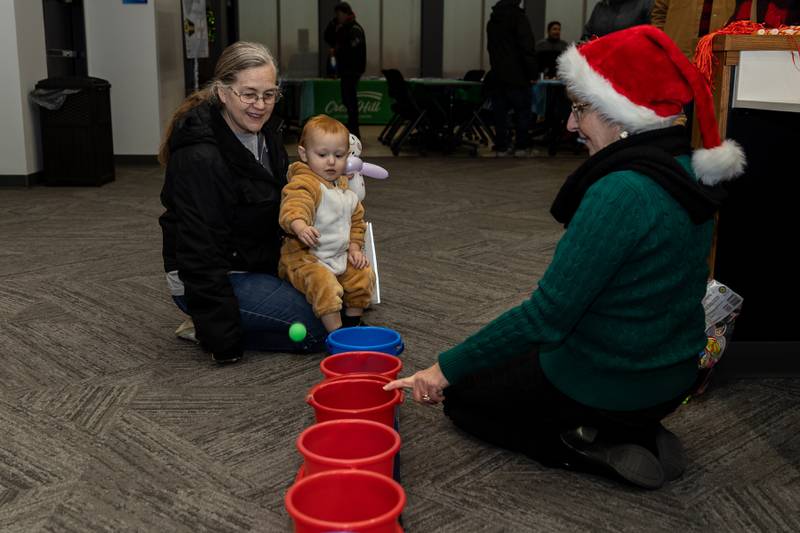 Crest Hill resident Mary Waddell helps Jacob Schalk play a game, led by Vicky Soliman, during Winterfest at Crest Hill City Center on Nov. 30, 2024.