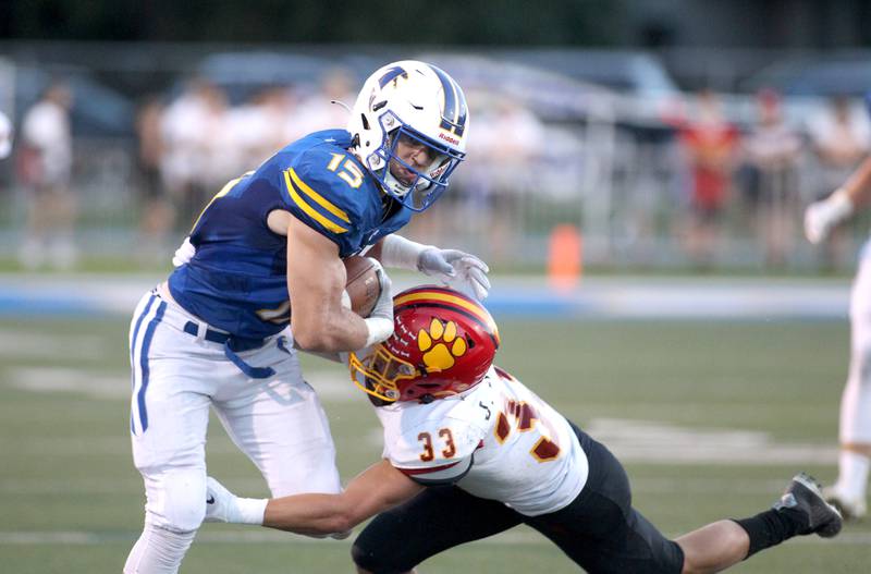Wheaton North’s Karsten Libby (15) is tackled by Batavia’s Jacob Jansey during a game at Wheaton North on Friday, Sept. 9, 2022.