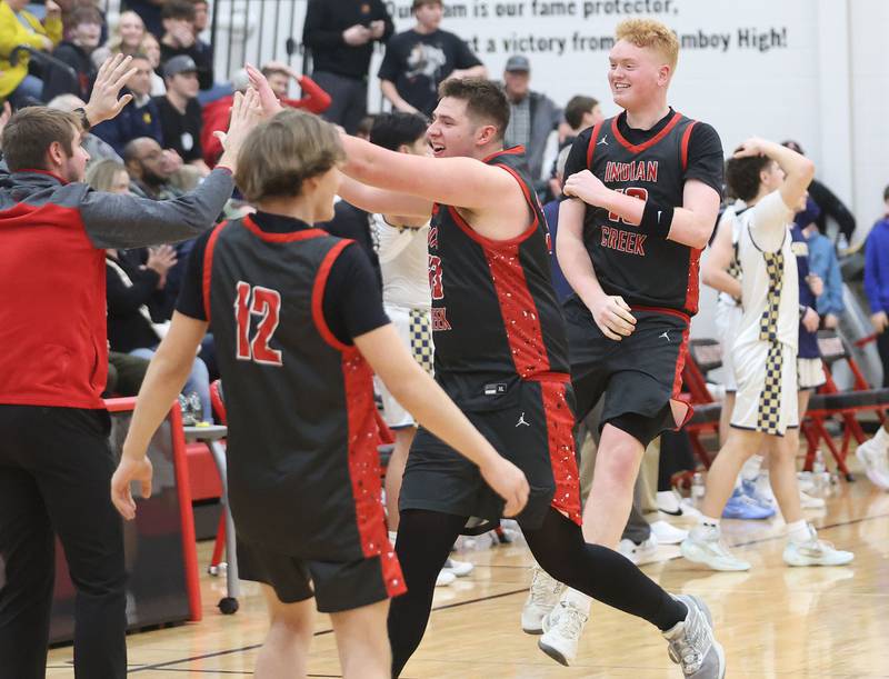 Indian Creek's Payton Hueber and Isaac Willis, hi-five coaches after defeating Marquette during the Class 1A Sectional game on Friday, March 6, 2026 at Amboy High School.