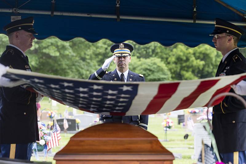 Col. Adam Dietrich salutes as the flag draped over U.S. Army Cpl. Richard Seloover’s casket is removed for presentation Tuesday, June 4, 2024. Seloover’s remains were identified early this year, more than 70 years after he died while fighting in the Korean War. He was buried Tuesday in Rock Falls.