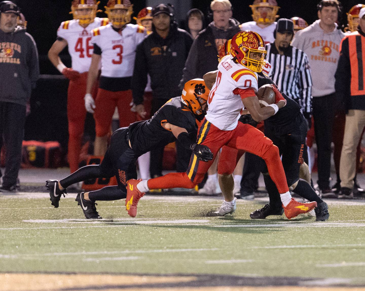 Batavia's Darin Ashiru runs for a gain as Wheaton Warrenville South's Brody Faulstitch goes for the tackle on Friday, Oct. 24,2025 in Wheaton.