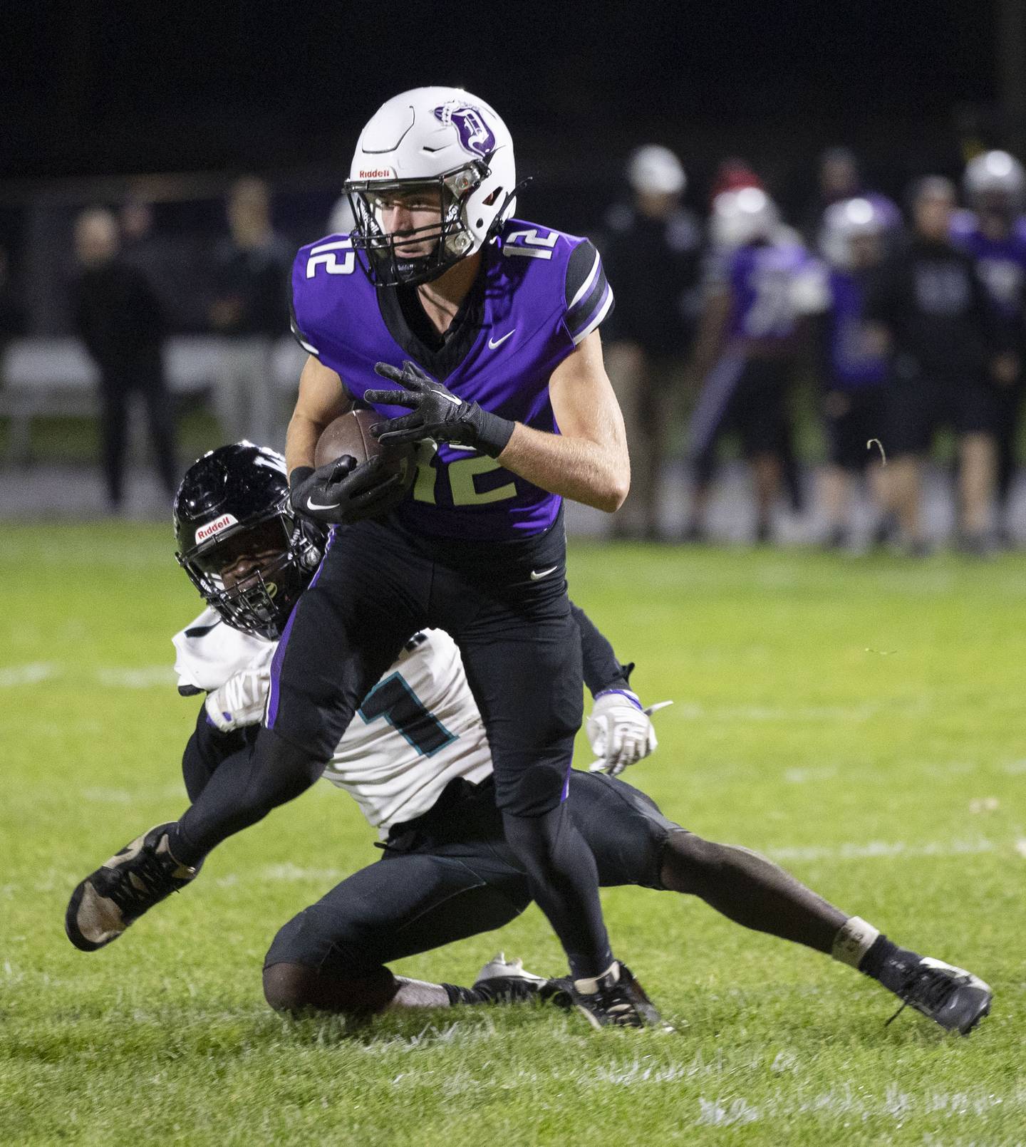 Dixon’s Jackson Koehler breaks a tackle against Woodstock North’s JR Fadahunsi Friday, Oct. 31, 2025, in the Class 4A football first round playoffs.