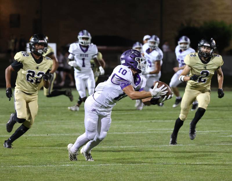 Rochelle's Dylan Manning makes a diving catch ahead of two Sycamore defenders during their game Friday, Sept. 19, 2025, at Sycamore High School.