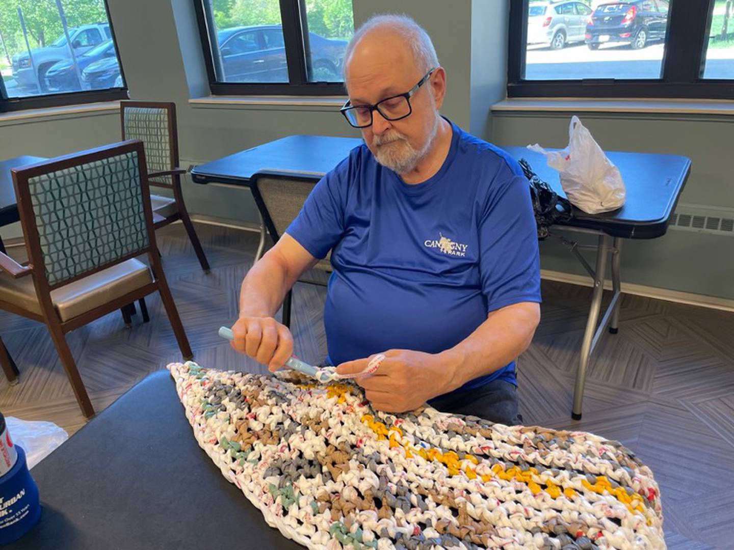 Oak Trace resident Wayne Wheatley makes recycled mats for the homeless.