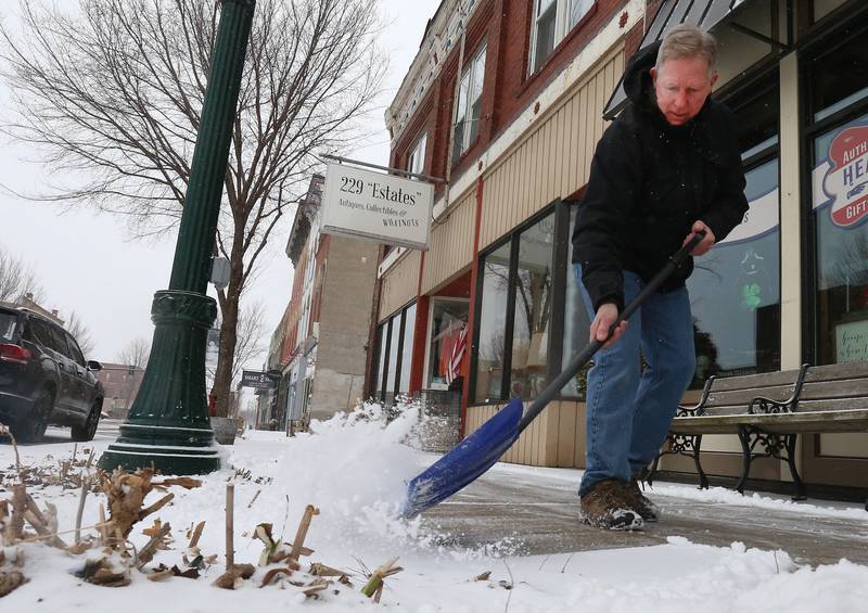 Hank Wolf shovels snow off of the sidewalk in the 200 block of West Main Street on Wednesday, Feb. 12, 2025 downtown Ottawa.
