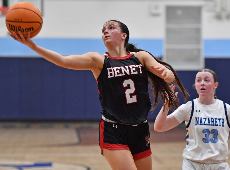 Benet’s Sailer Jones sails to the basket with a layup in front of Nazareth’s Molly Moore (33) during a game on December 13, 2025 at Nazareth Academy in LaGrange Park.