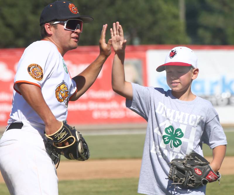 Pistol Shrimp's Justin Rios, hi-fives Henry Wicke after delivering the ceremonial first pitch on Monday, June 20, 2022 at Schweickert Stadium at Veterans Park in Peru.
