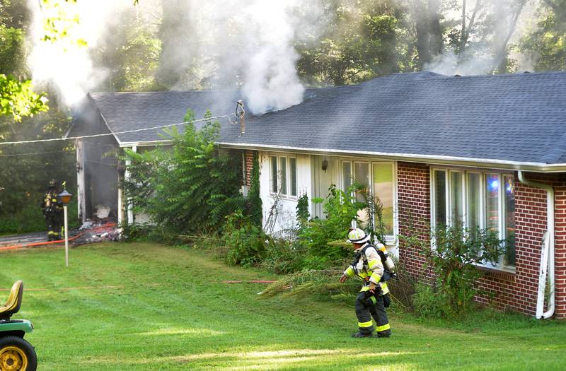 Mt. Morris Deputy Fire Chief Mark Lewis helps assess a fire at 540 E. Elizabeth Road, southeast of Oregon, on Wednesday, Aug. 20, 2025. Mt. Morris was one of four area departments that assisted Oregon firefighters at the scene.