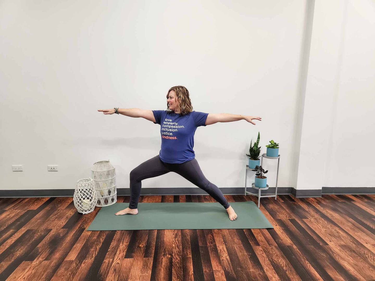 Warrior 2: Standing in the middle of your mat, step your feet apart pointing
your right toes toward the top of the mat and your left toes to the side. Bend
your right knee, lift your arms to a T and turn to look over your right fingertips.
Repeat on the other side with left toes pointing toward the bottom of the mat
and right toes pointing toward the side.