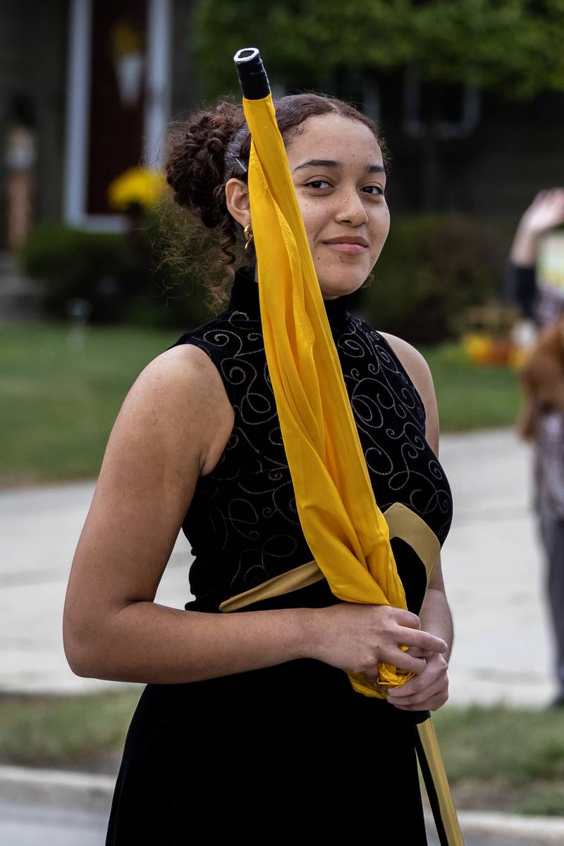 Jasmine Yates of the color guard walks along Glenwood Ave. in Joliet during the Joliet West homecoming parade on Oct. 10, 2025.