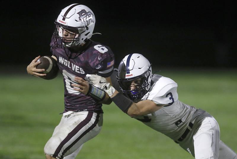 Cary-Grove's Preston Walsh tackles Prairie Ridge's Luke Vanderwiel one yard short of a first down to seal Cary-Grove’s victory in a Fox Valley Conference football game on Friday, Sept. 27, 2024, at Prairie Ridge High School.