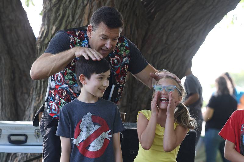 Randy Bernstein, of Magic by Randy, plays a game with a few young volunteers at the Autumn Family Fun Fest on Saturday, Sept. 23, 2023 in Plainfield.