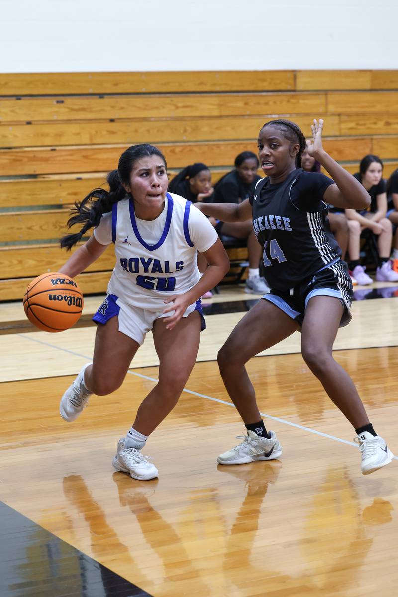 Rosary's Kayla Garcia drives to the lane against Kankakee's Jasyia Wesby during the Kays' 75-28 victory over Rosary at the Reed-Custer Classic on Monday, Nov. 17, 2025.